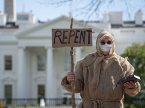 Ron Van of Grand Rapids, Mich., wears a face covering as he evangelizes near the White House on April 3, 2020, in Washington, D.C. Last week, the White House said they expect 100,000 to 240,000 people will die in the United States from the COVID-19 pandemic.