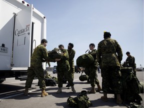 Members of the Canadian Forces pack busses at Denison Armory to convoy to CFB Borden amid the spread of the coronavirus disease (COVID-19) on April 6, 2020 in Toronto, Canada. Troops will remain ready to respond to any requests made by any levels of government in Canada to help fight the pandemic.