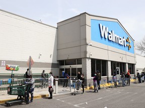 People wearing masks and gloves wait to enter a Walmart on April 17, 2020 in Uniondale, New York. The World Health Organization declared coronavirus (COVID-19) a global pandemic on March 11th.