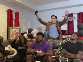 In this still image from video provided by the NFL, Josh Jones, seated centre, watches as others begin to celebrate as he is selected by the Arizona Cardinals during the third round of the 2020 NFL Draft on April 24, 2020.