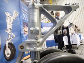 Gilles Labbé, President and CEO of Héroux-Devtek Inc, framed within landing gear, addresses members of the Media and Mr. Sam Hamad, Québec Minister of Employment and Social Solidarity at Heroux Devtek plant in Longeuil on October 4, 2007. A  financial contribution was granted by Investissement-Québec and Emploi-Québec to Héroux-Devtek.  Héroux-Devtek supplies the Aerospace market in both the commercial and military sectors with landing gear, airframe structural components including kits, and aircraft engine components. (THE GAZETTE/Vincenzo D'Alto)/ AT THE HEROUX-DEVTEK FACILITY IN LONGUEUIL, CEO GILLES LABBE ANNOUNCES A MAJOR INVESSTMENT GEARED TO RAISING PRODUCTIVITY BY 20 PER CENT AT ALL FOUR OF ITS LANDING-GEAR PLANTS IN QUEBEC.