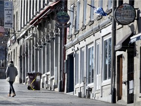 A lone person has Place Jacques-Cartier to himself as businesses are ordered closed during the coronavirus pandemic in Montreal, March 31, 2020.