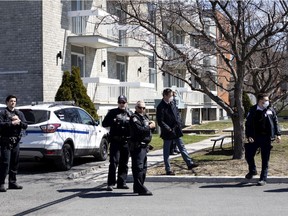 Security officers are seen in the parking lot of the Notre-Dame-de-la-Victoire residence on April 20.