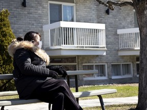 Christiane L'Amoureux waits for an opportunity to see her father, Gilles L'Amoureux, on his balcony at Notre-Dame-de-la-Victoire, a private CHSLD, April 20, 2020.