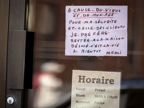 A sign hangs in the now closed Salon Denis, announcing the shop is closed until further notice as the city deals with the coronavirus pandemic in Montreal, on Friday, April 24, 2020. (Allen McInnis / MONTREAL GAZETTE) ORG XMIT: 64307