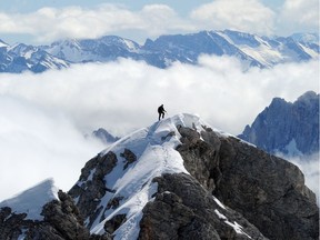 A mountain climber stands atop Jubilate Cest mountain near Gamisch-Patenkirchen, Germany. "While there is a similarity between COVID-19 and high altitude sickness patients in that they both have low oxygen levels, the nature of the disease is entirely different," Dr. Christopher Labos writes. On the other hand, he notes, climbing a mountain is one potential way of keeping a safe distance from others —though hardly the simplest.