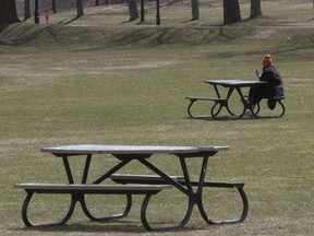 A Montreal resident speaks to a friend on her smartphone, while alone at Jeanne-Mance park on Friday April 17, 2020. "Now is not seeing loved ones who live elsewhere, but now is also teaching me to love talking on the phone — which I normally hate — because now, the phone is all I’ve got. Now is also not knowing when I will see them again in the flesh," Lise Ravary writes.