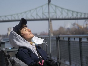 Ola Kolodziej takes a mask break while taking in some sunshine on a cold morning at the Old Port on Thursday, April 23, 2020.