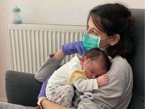 Vanesa Muro  holding her baby Oliver, born on March 13, 2020, at their home in Madrid. For 10 days after giving birth to her first child, Muro was not allowed near him after she tested positive for coronavirus.