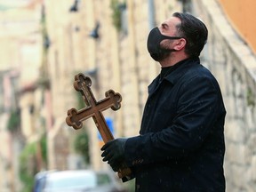 A Christian pilgrim prays while making his way alone in the Procession of the Way of the Cross to mark Good Friday in Jerusalem on April 10. All cultural sites in the Holy Land are shuttered, regardless of their religious affiliation.