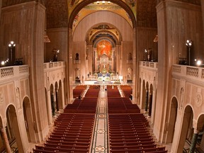 Members of the clergy arrive to celebrate an Easter Sunday mass in front of empty pews at the Basilica of the National Shrine of the Immaculate Conception in Washington, D.C., on Sunday, April 12, 2020, as the Basilica remained closed to the public because of the COVID-19 coronavirus pandemic.