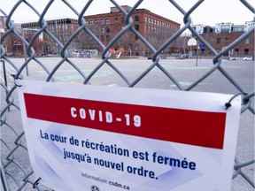 A closed schoolyard is seen through its fence in Montreal, Monday, April 27, 2020. The Quebec government has announced plans to reopen elementary schools in the province.