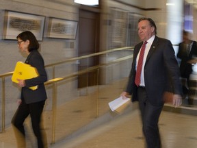 Quebec Health Minister Danielle McCann and Quebec Premier Francois Legault walk to a news conference on the COVID-19 pandemic, April 14, 2020.