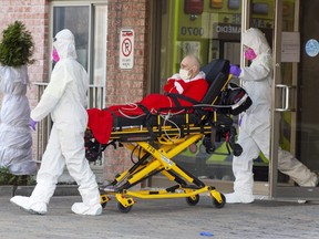 First responders transport a resident of a seniors home to hospital, Tuesday, March 31, 2020 in Montreal.