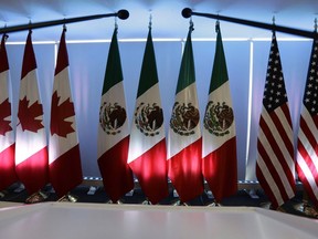 National flags representing Canada, Mexico, and the U.S. are lit by stage lights at the North American Free Trade Agreement, NAFTA, renegotiations, in Mexico City on Sept. 5, 2017.