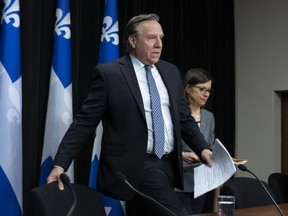 Quebec Premier Francois Legault and Quebec Health Minister Danielle McCann, right, arrive at a news conference on the COVID-19 pandemic, Wednesday, April 15, 2020 at the legislature in Quebec City.