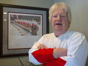 Pat Stapleton stands next to a photo of Team Canada at the 1972 Summit Series in 2010.