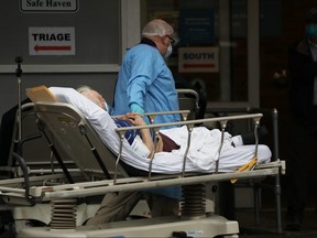 Medical workers take in patients at a special coronavirus intake area at Maimonides Medical Center April 3, 2020 in New York. (Spencer Platt/Getty Images)