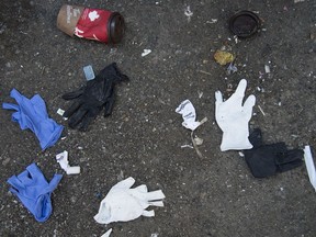 Discarded protective gloves are pictured on the street in downtown Vancouver, Tuesday, April 7, 2020. The COVID-19 pandemic is introducing a new type of litterbug as people are dropping gloves and masks.