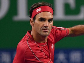 Roger Federer hits a return against Albert Ramos during their second round men's singles match at the Shanghai Masters in Shanghai, China, Oct. 8, 2019.