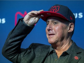 Gary Stern tries on a Montreal Alouettes cap at press conference announcing him, with partner Sid Spiegel, as new owners of the team, in Montreal on Jan. 6, 2020.