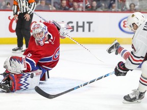 Montreal Canadiens' Charlie Lindgren slides across the crease to stop Chicago Blackhawks Dominik Kubalik during third period in Montreal on Jan. 15, 2020.