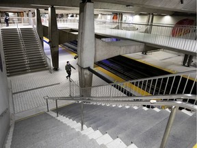 Two passengers make their way towards the métro platform at the Peel Station, mid afternoon, in Montreal, on Monday, May 4, 2020.