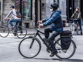 Some cyclists have taken to riding with a mask on the bike routes in Montreal on Wednesday May 6, 2020. Dave Sidaway / Montreal Gazette ORG XMIT: 64363