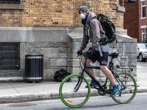 Some cyclists have taken to riding with a mask on the bike routes in Montreal on Wednesday May 6, 2020. Dave Sidaway / Montreal Gazette