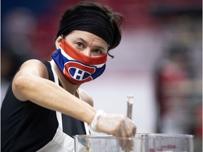 A Groupe CH food-services worker helps prepare 16,000 meals at the Bell Centre on May 5, 2020 to help support La Tablée des Chefs, an organization with a mandate that includes providing food for Moisson Montréal.