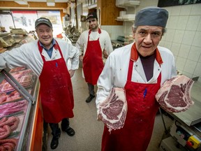 Butchers Roberto Lamarre, left, Steve Ottoni, right, and Vincent Lacroix are seen at Boucherie Tranzo in Notre-Dame-de-Grace on Wednesday, May 6, 2020.