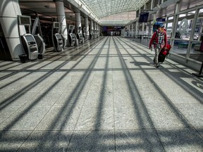 A man walks through an empty Montréal-Pierre Elliott International Airport in Montreal May 7, 2020.