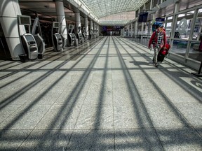 A man walks through an empty Montréal-Pierre Elliott International Airport in Montreal Thursday May 7, 2020.