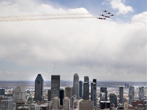 The Snowbirds perform a fly past over the city of Montreal on Thursday, May 7, 2020.