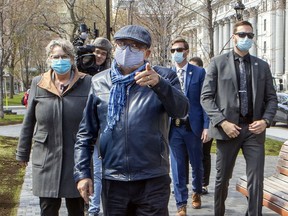 Dr. Horacio Arruda, Quebec director of public health, admonishes a photographer for not wearing a mask during a visit to a day centre for the homeless in Place du Canada in Montreal on Friday, May 8, 2020.