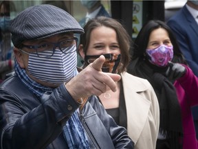 Quebec's public-health director Horacio Arruda, left,  Montreal's public-health director Dr. Mylene Drouin, centre, and Montreal mayor Valerie Plante all sport face coverings while visiting a mobile testing clinic for COVID-19 in Montreal North on Friday May 8, 2020.