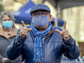 Dr. Horacio Arruda, Quebec director of public health, gestures while speaking to reporters during a visit to a day centre for the homeless in Place du Canada in Montreal Friday May 8, 2020.