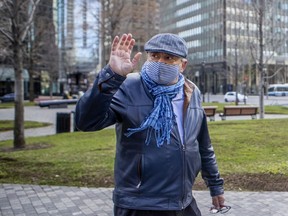 Dr. Horacio Arruda, Quebec's director of public health, waves goodbye after a visit to a day centre for the homeless at Montreal’s Place du Canada on May 8, 2020.