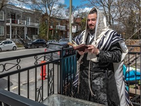 Chesky Spira praying on the balcony of his Outremont home. With synagogues closed during the COVID-19 pandemic, Spira and other members of Outremont's Hasidic community take to their balconies three times daily to pray aloud. They stand outdoors, socially distanced from fellow Jews on nearby balconies, to achieve the quorum of 10 men required by Jewish law for public prayer.
