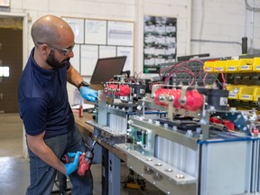 Production engineer Matthieu Dagorn is back to work at Effenco in Montreal on Monday May 11, 2020 thanks to the resumption of manufacturing and construction in Quebec. Effenco converts gas fuelled trucks to electric hybrids.