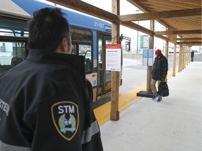 An STM inspector keeps an eye on the few train passengers disembarking at Bois-Franc station on Monday morning.