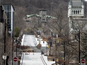 A sole pedestrian walks up what would normally be a busy McTavish St. at McGill University in April.