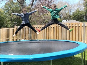 Quinn Martin, 8, left and his brother Hunter, 11, were taking advantage of the beautiful, sunny weather last week to enjoy their new trampoline in the backyard of their Chatham, Ont., home.