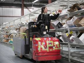 An SAQ worker readies online orders at an east-end warehouse in 2020.