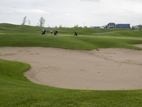 Golfers approach a green as they play a round of golf at the Club De Golf Metropolitain in 2018.