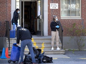 Parents collect their children's belongings from Grand-Héron school on Wednesday, May 13, 2020.