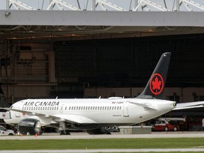 An Air Canada jet at a maintenance hangar at Trudeau airport in Montreal on Saturday May 16, 2020. The airline announced 20,000 layoffs because of the coronavirus pandemic.