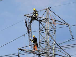 Hydro-Québec crews change the insulators on a series of transmission towers in Montreal.