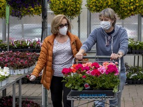 Maria Guarneri, left, and Joy Goodman wear masks while shopping for plants at Pépinière Jasmin in St-Laurent May 16, 2020.