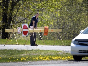 A woman comes up against a roadblock as she tries to exit Oka provincial park on May 20.